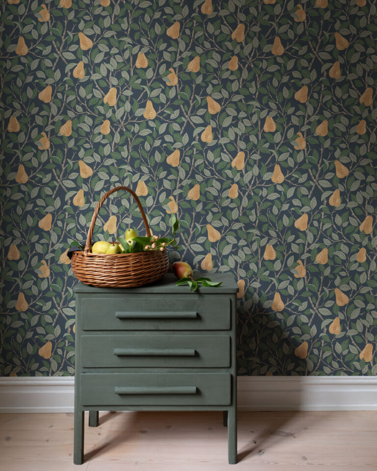 Blue wallpaper with beautiful foliage and pears in a hallway with a green dresser