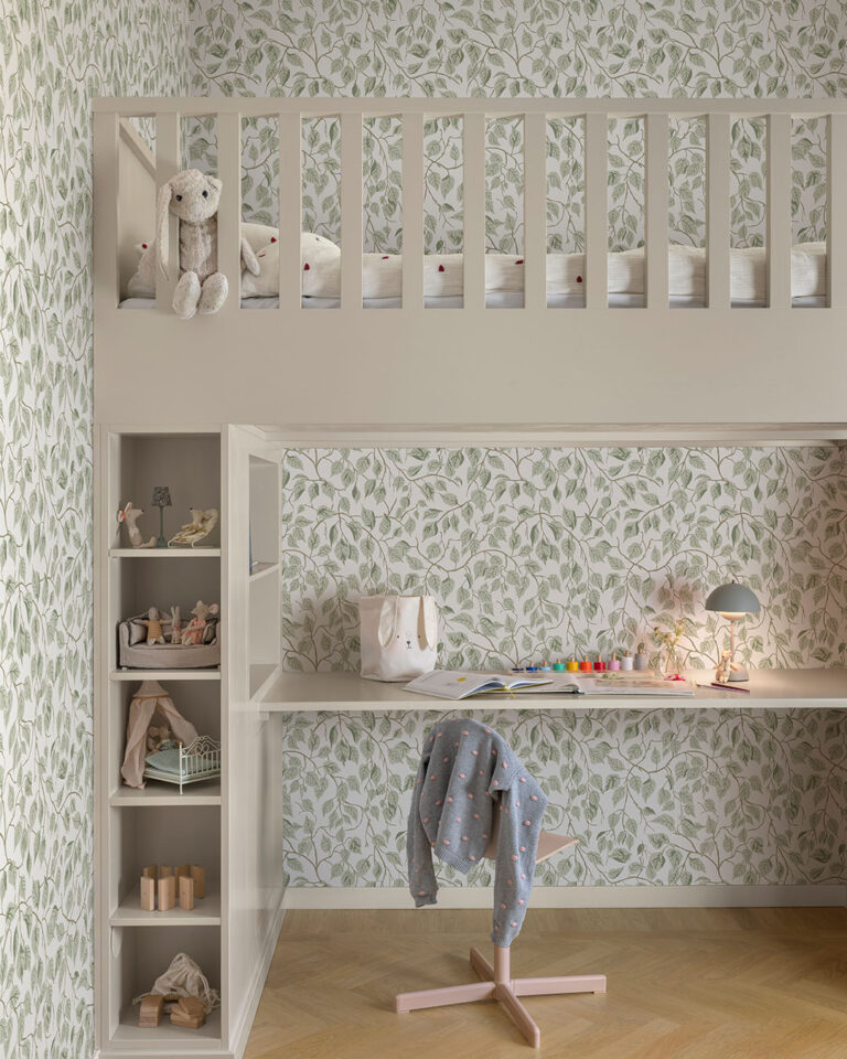 Green and white wallpaper with leaves in a child's room with a bunk bed