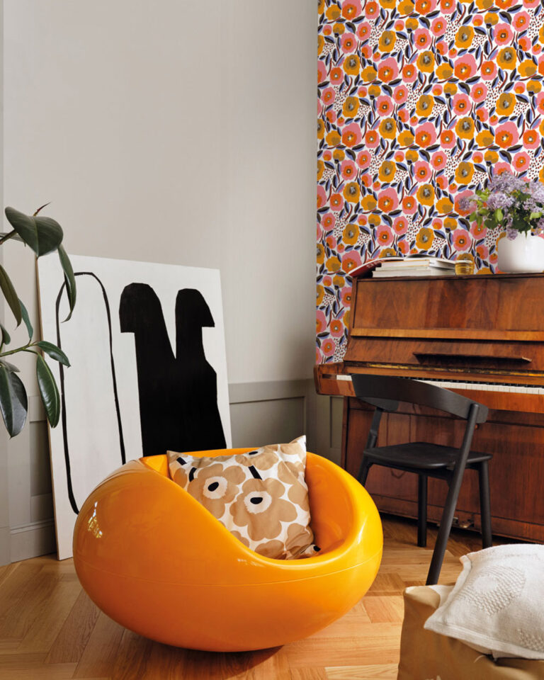 Floral retro wallpaper from Marimekko in a living room with a yellow plastic armchair