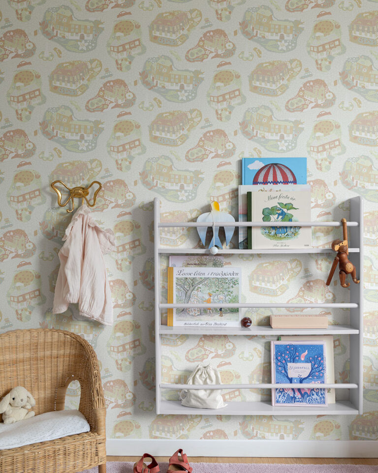Beige and red wallpaper featuring cartoon houses in a child's room with a bookshelf and a chair