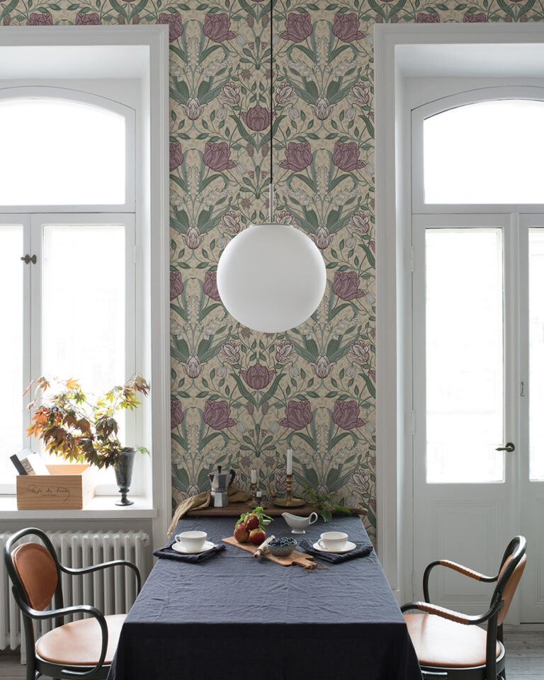 A kitchen with floral-patterned wallpaper featuring pink flowers and green, curving leaves against a warm beige background.