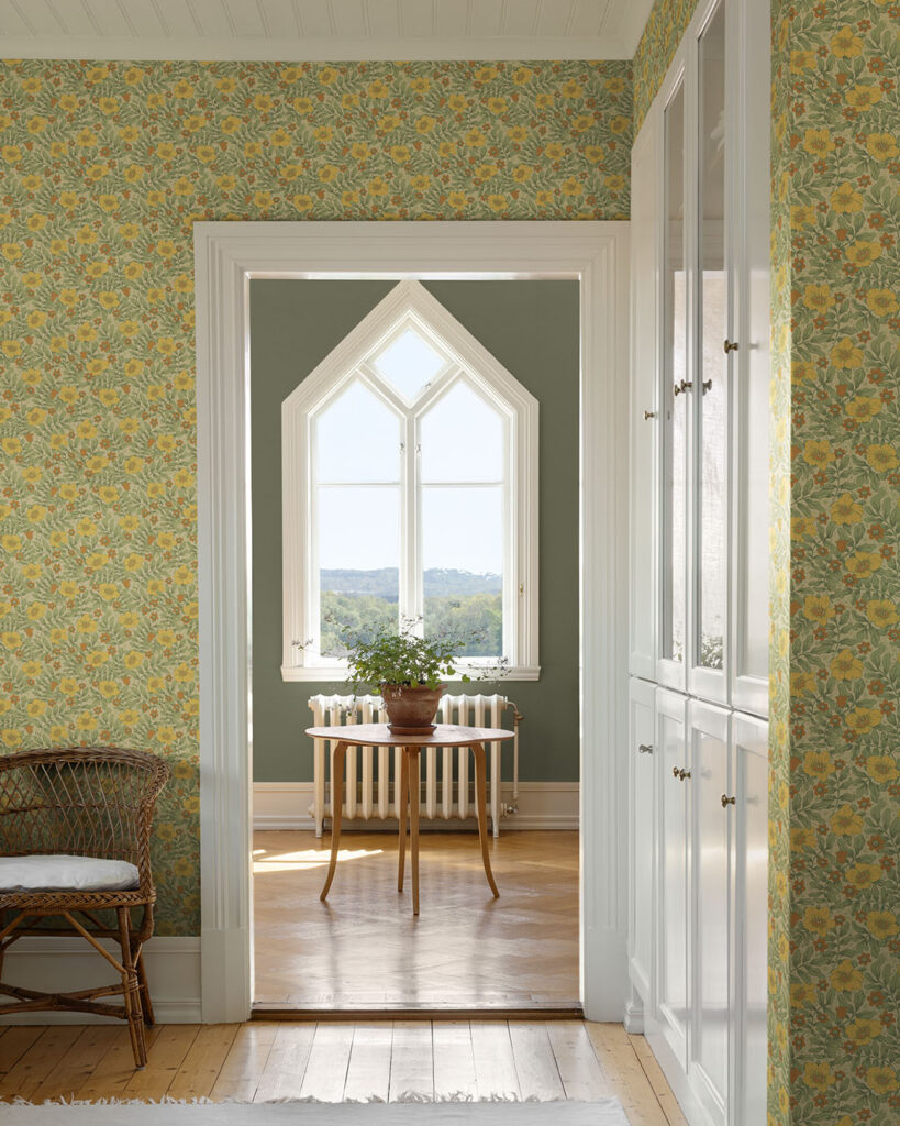 Yellow and green floral wallpaper in a bright, open hallway