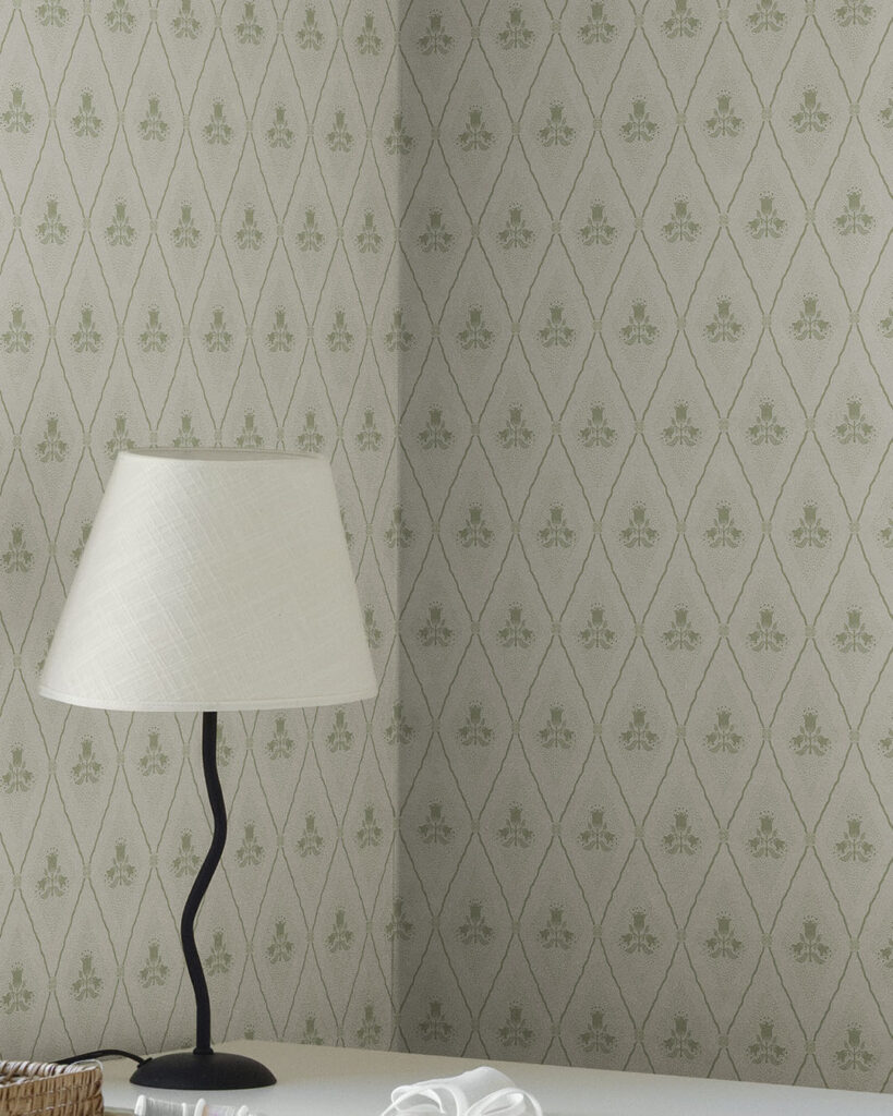 White-and-green floral wallpaper in an office with a lamp
