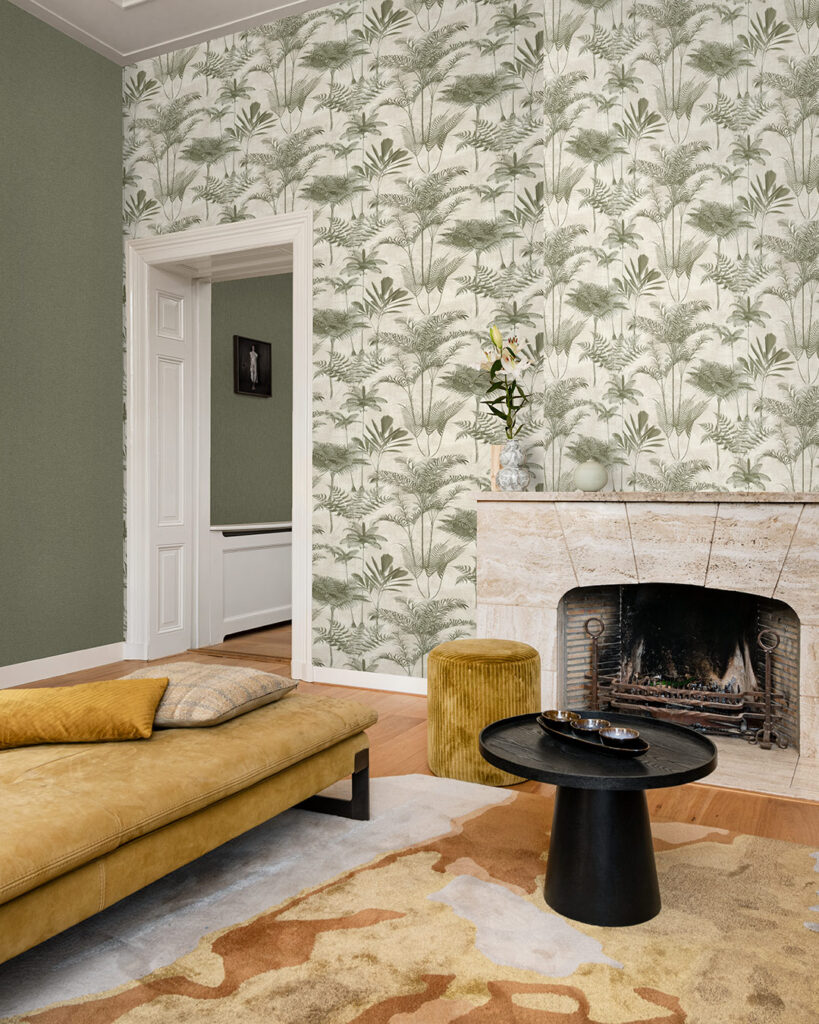 Green wallpaper with trees in the living room, featuring a yellow sofa and a yellow-orange rug.
