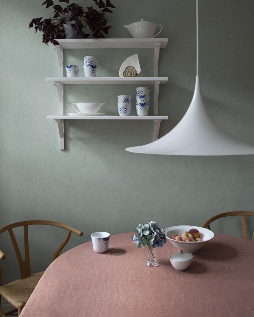 kitchen with calico wallpaper and a table set with a tablecloth