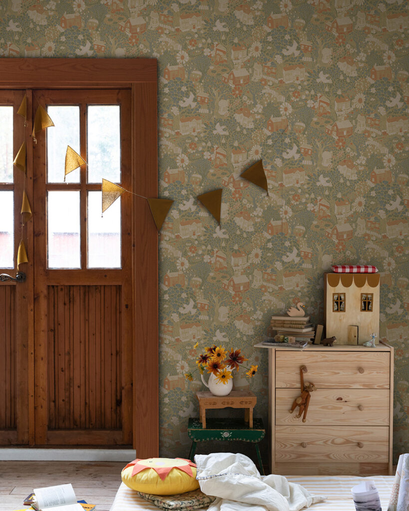 A lively children's room with colorful and playful wallpaper featuring houses and birds