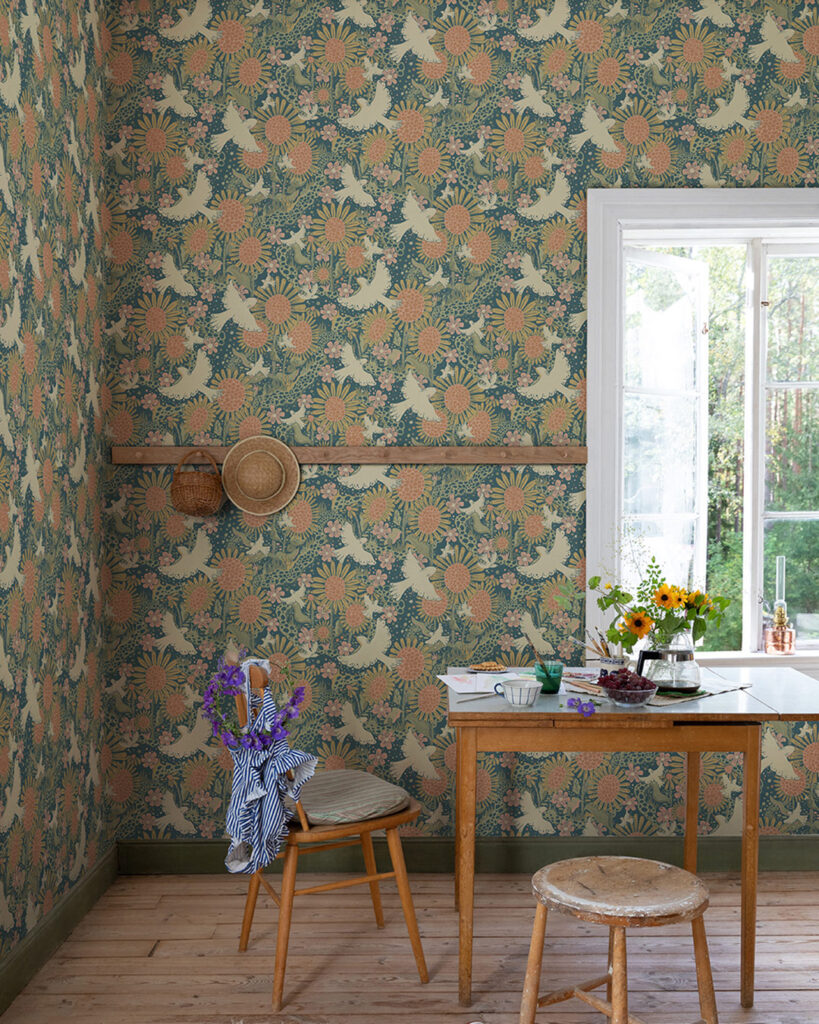 Wallpaper with a blue background featuring flowers and birds in a living room with a wooden table