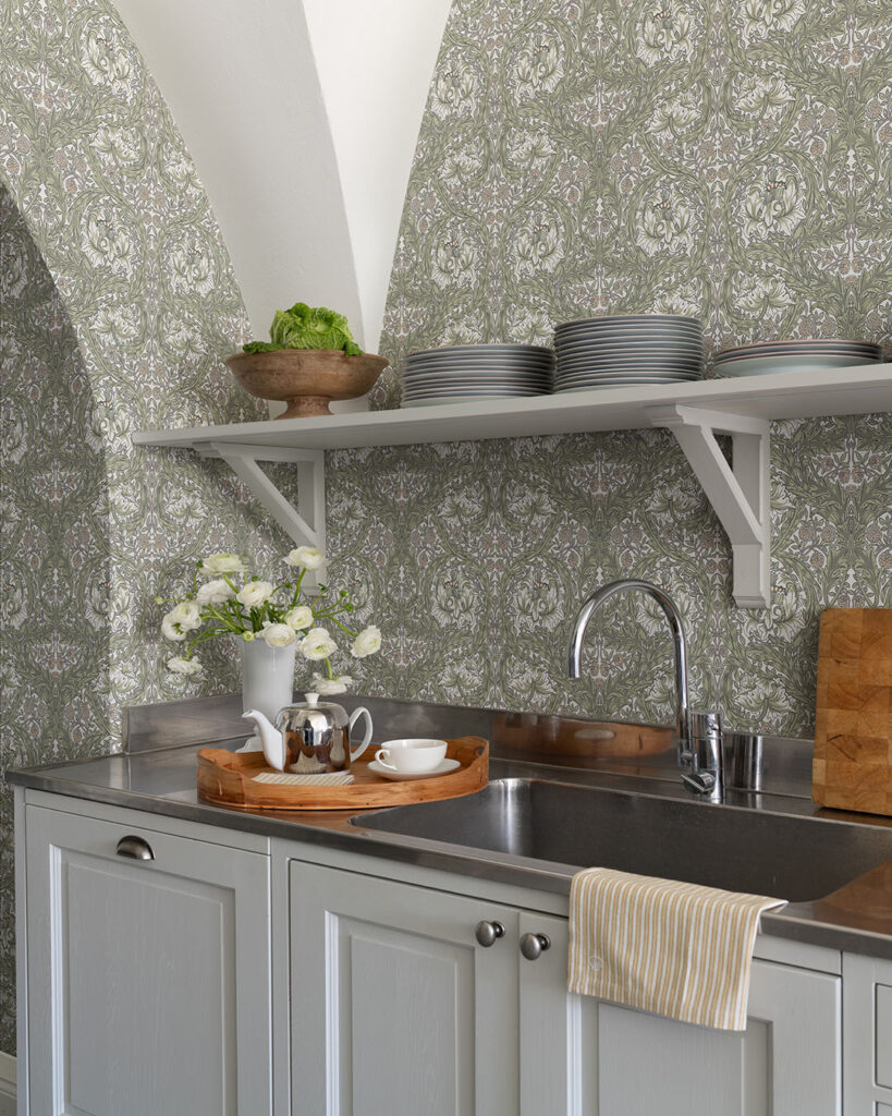 Wallpaper featuring leaves and flowers in a kitchen with china and wooden trays on a kitchen counter