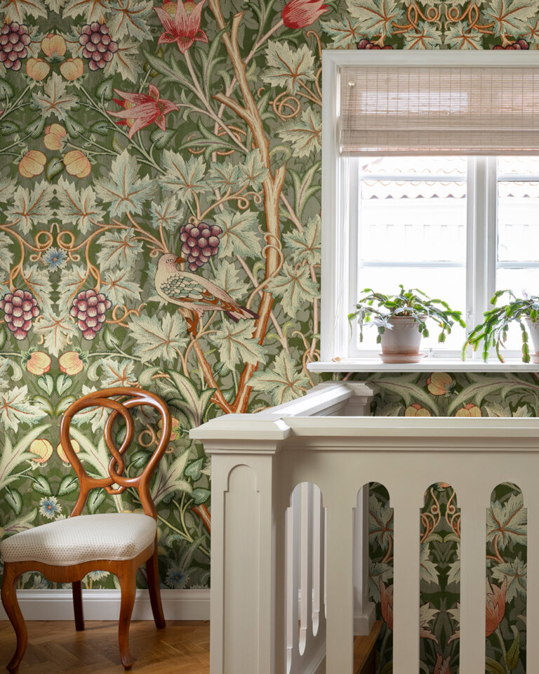 hallway and staircase with William Morris wallpaper featuring plants and birds