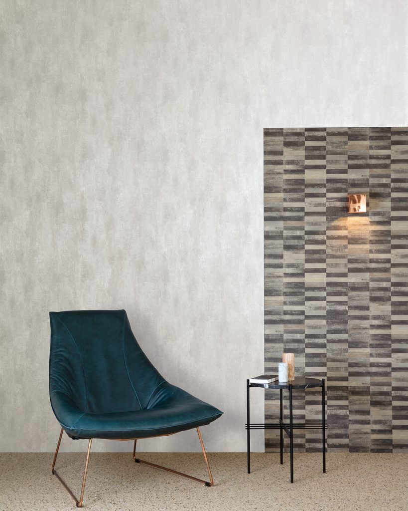 Silver-gray wallpaper in a living room behind a blue armchair