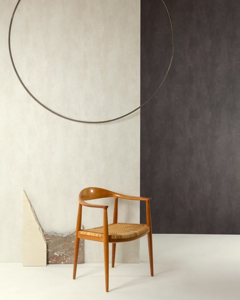 White wallpaper in a hallway behind a wooden chair