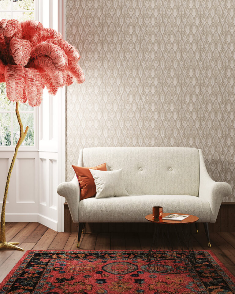 Beige geometric Art Deco wallpaper behind a small gray sofa