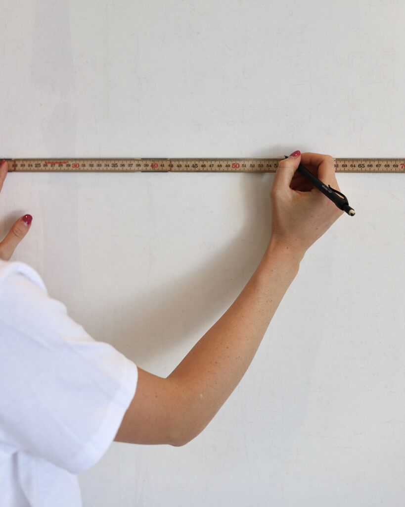Measure out the first strip with a folding rule when you're wallpapering